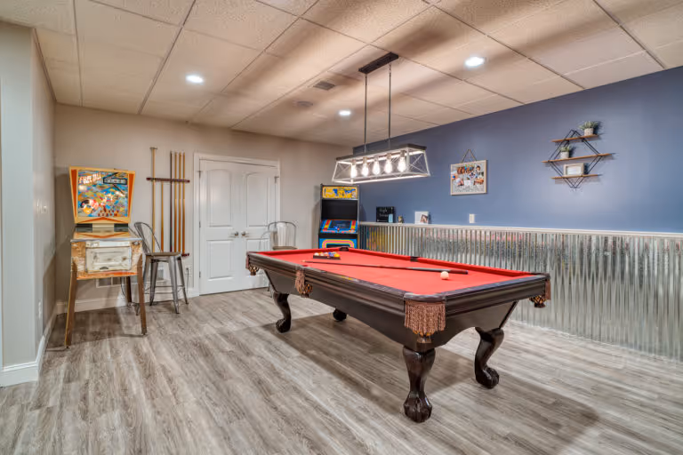 Stylish billiard room with a red pool table and retro arcade games in Mechanicsburg, PA.
