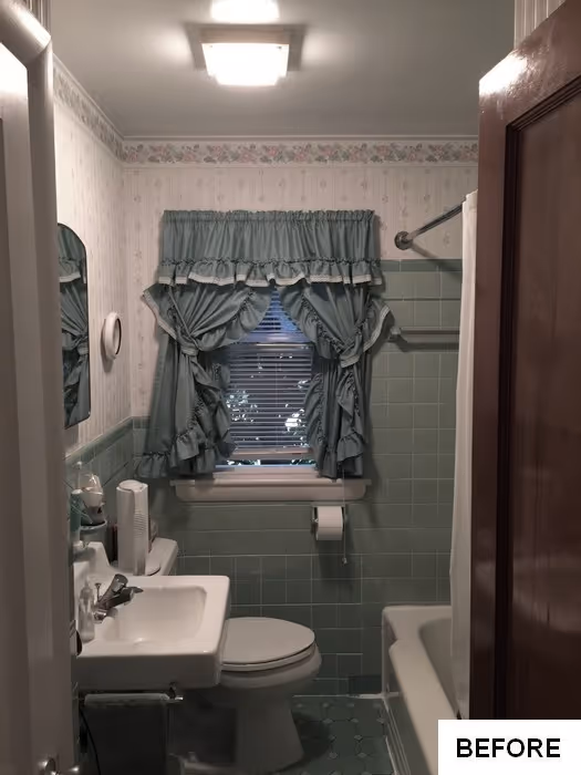 Vintage bathroom featuring mint green tiles and floral wallpaper in new cumberland, pa