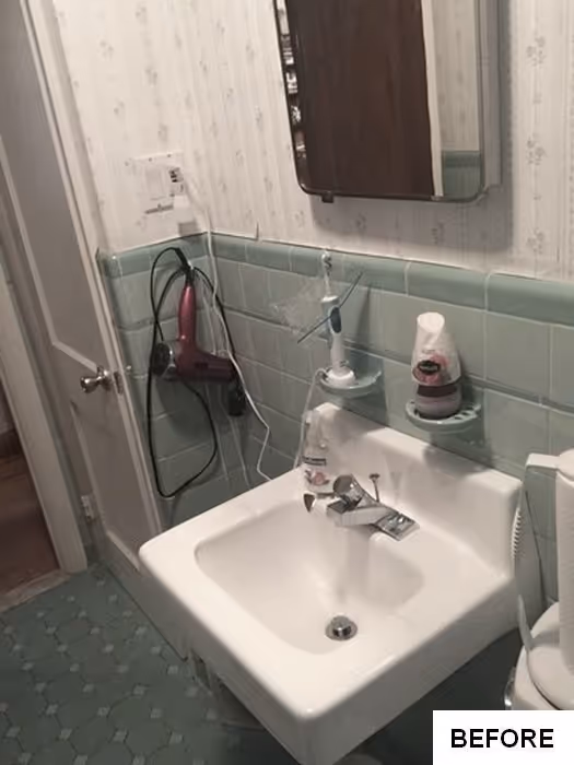 Small bathroom with green tiles, a sink, and a brown mirror in New Cumberland, PA