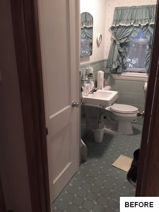 Small bathroom with green hexagonal tile, white fixtures, and floral curtains in new cumberland, pa