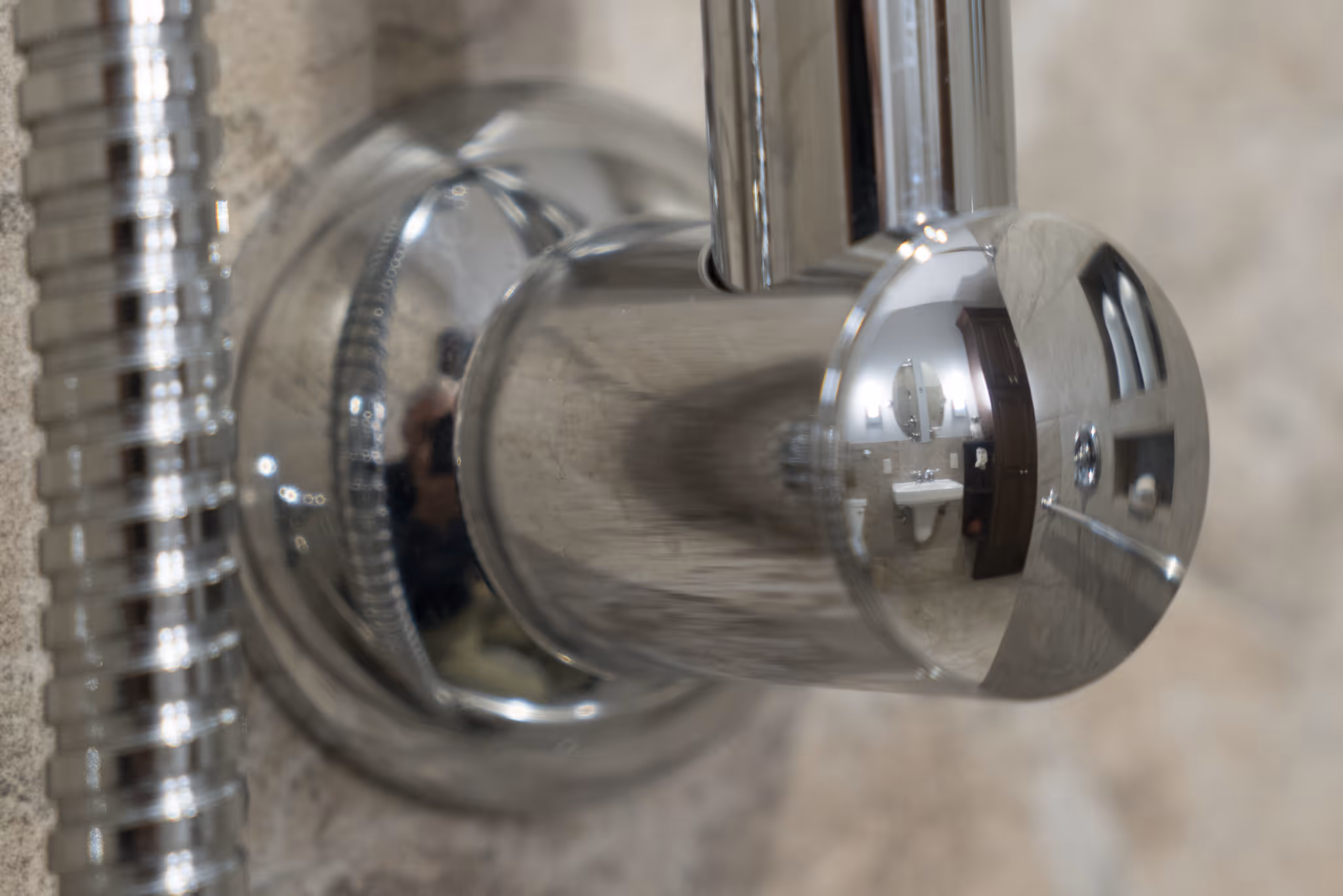 Polished chrome bathroom faucet reflecting elegant design elements in a bathroom in New Cumberland, PA.