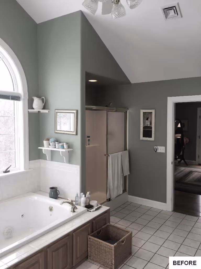 Spacious bathroom with green walls, white tub, and natural light in Hummelstown, PA