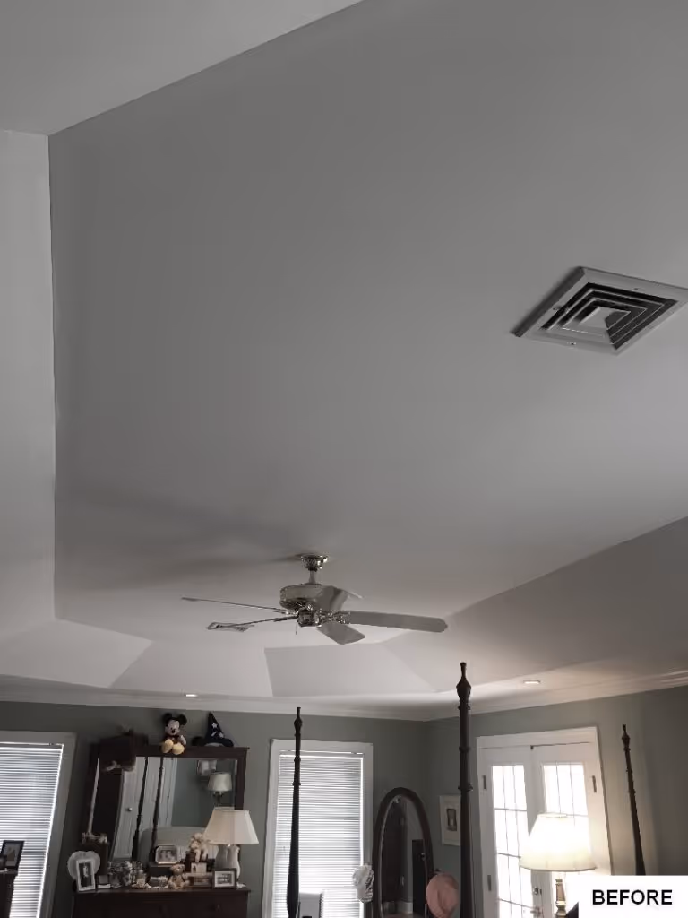 Spacious bedroom features a ceiling fan, gray walls, and decorative furniture in Hummelstown, PA.