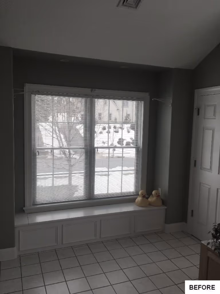 Cozy entryway with a bay window, white cabinetry, and ceramic tile floors in Hummelstown, PA.