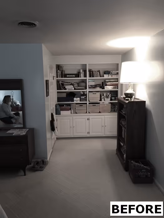 Cozy bedroom nook with built-in shelves, lamp, and mirror in Mechanicsburg, PA.