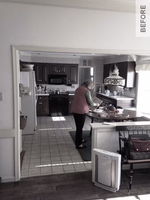 A traditional kitchen in Camp Hill, PA featuring dark wood cabinets, a dining area, and sunlight streaming through the windows.