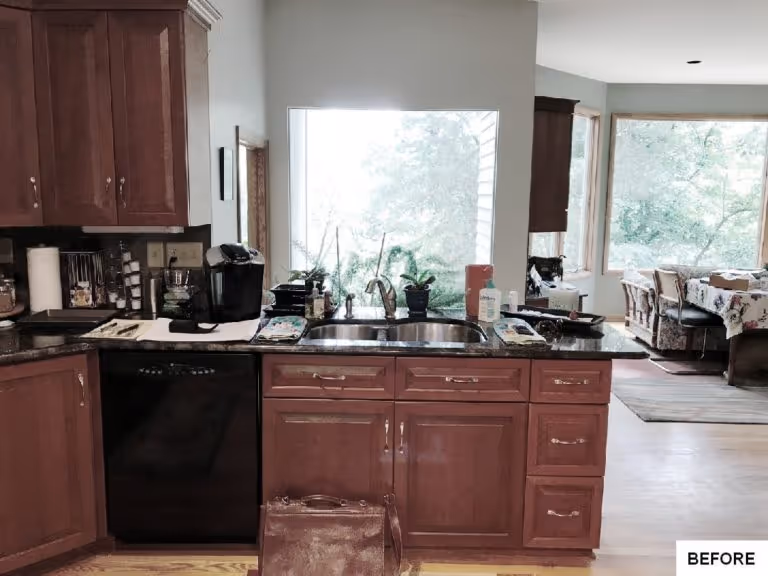 Kitchen with wood cabinets, black appliances, and a large window, located in Camp Hill, PA