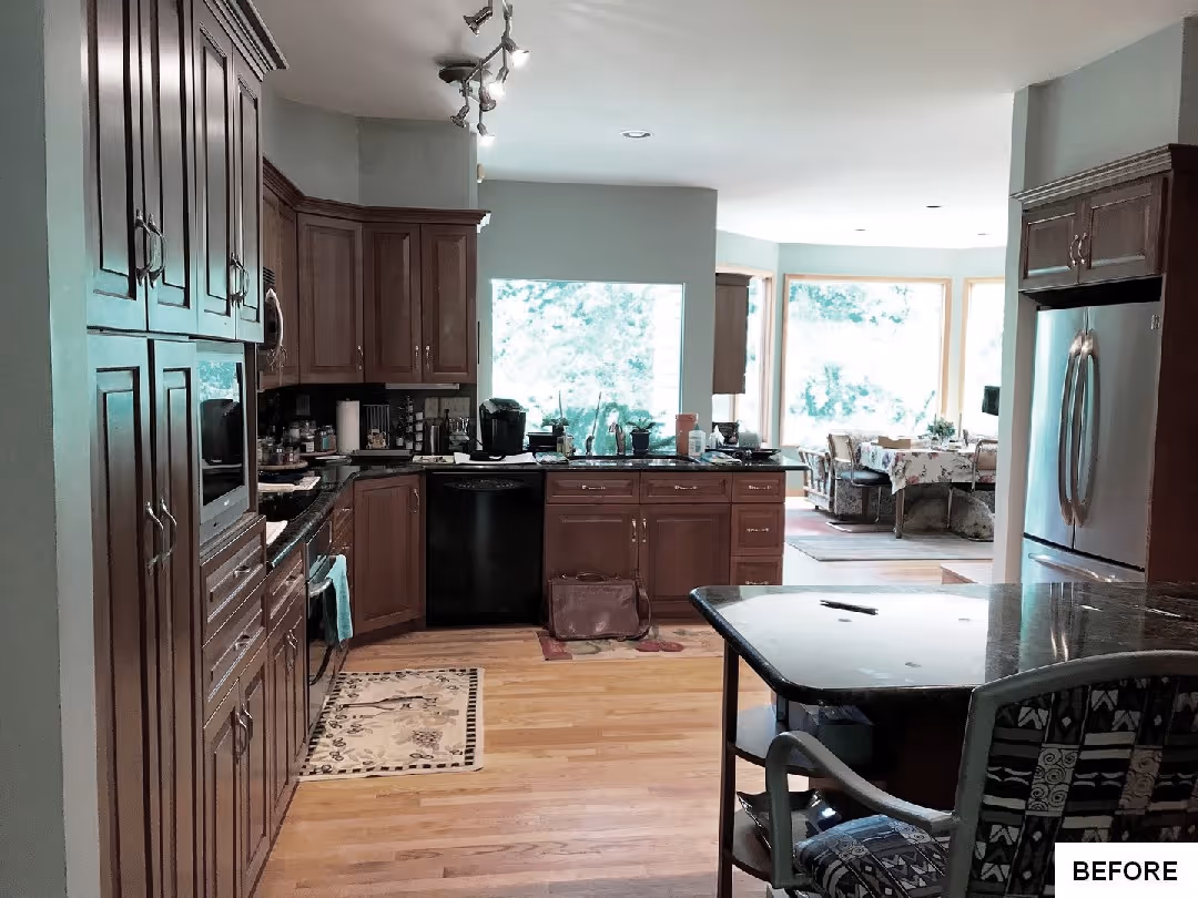 Transitional kitchen with wood cabinets and granite countertops in Camp Hill, PA, featuring an open design and natural light.