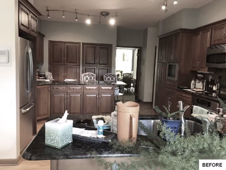 Traditional kitchen in Camp Hill, PA featuring wooden cabinetry and a dark countertop with various items on it.