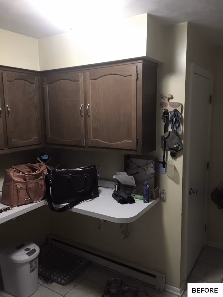 An organized utility room in Mechanicsburg, PA with dark wood cabinetry, a white countertop, and storage solutions.