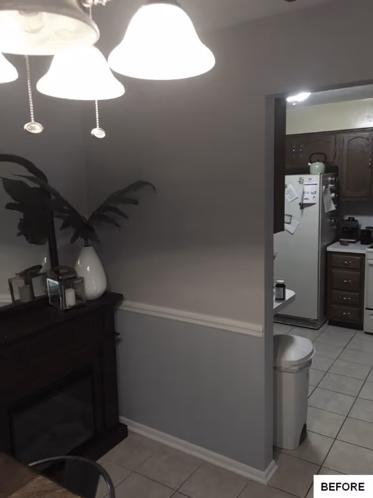 Cozy transitional kitchen space featuring gray walls, tile flooring, and a dark wood accent.
