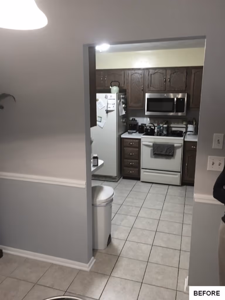 Contemporary kitchen with light gray walls, dark wood cabinets, and modern appliances in Mechanicsburg, PA