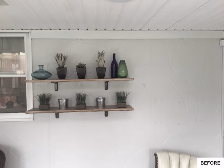 Modern living room design in Mechanicsburg, PA featuring decorative shelves with plants and colorful vases.