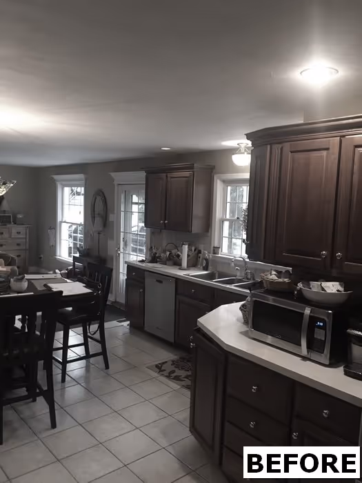 Spacious kitchen in new cumberland, pa featuring dark wood cabinets, white countertops, and plenty of natural light.