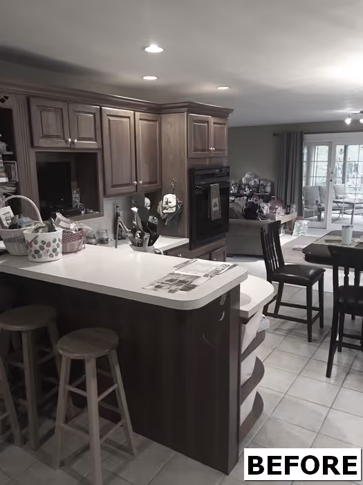 Cozy kitchen with wood cabinets, gray countertops, and bar stools in New Cumberland, PA