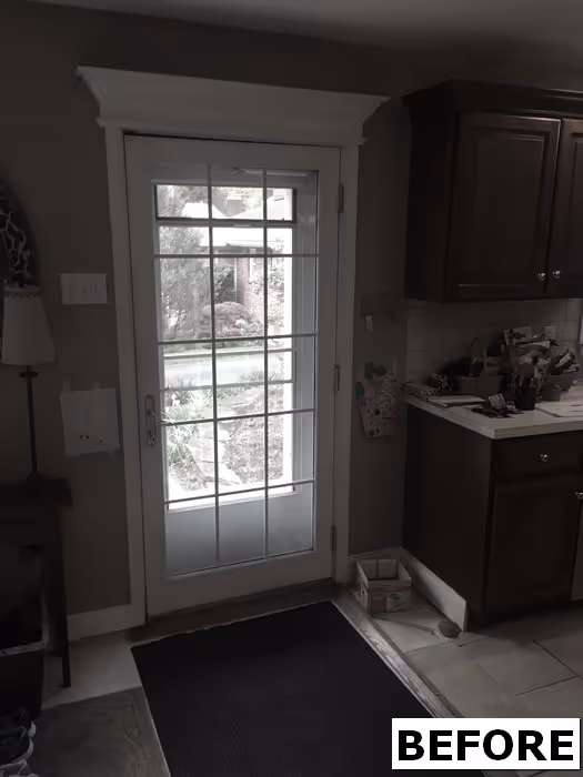 Welcoming entryway with white French doors and dark wood cabinets in New Cumberland, PA, featuring a cozy atmosphere.