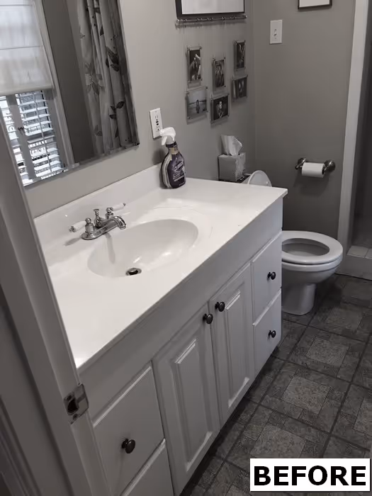 Traditional bathroom with white cabinetry and marble countertop, featuring a single sink and neutral colors in new cumberland, pa