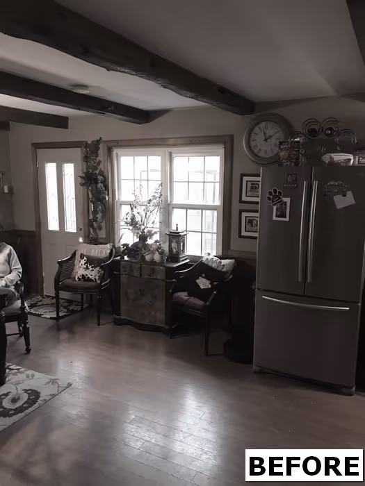 cozy living room in mechanicsburg, pa with rustic wooden beams, a modern fridge, and floral decor