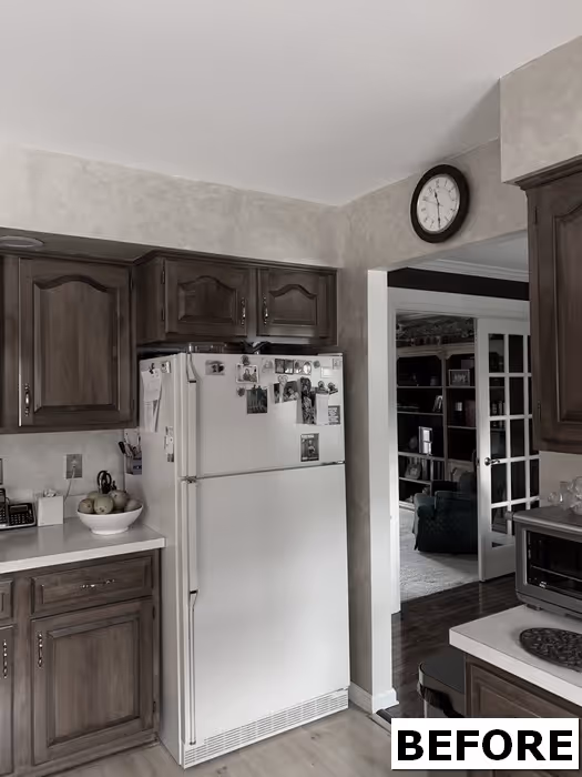 Traditional kitchen with wooden cabinets, white refrigerator, and subtle textured walls in Mechanicsburg, PA.
