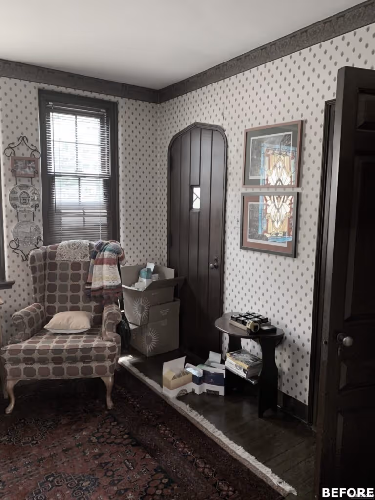 Cozy transitional living room in Harrisburg, PA with patterned wallpaper, antique furnishings, and decorative elements.