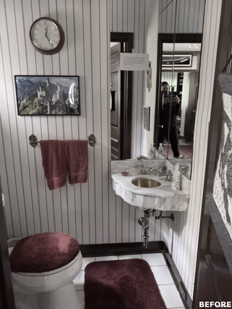 Transitional bathroom featuring a marble sink, burgundy accents, and a wooden door design in Harrisburg, PA.