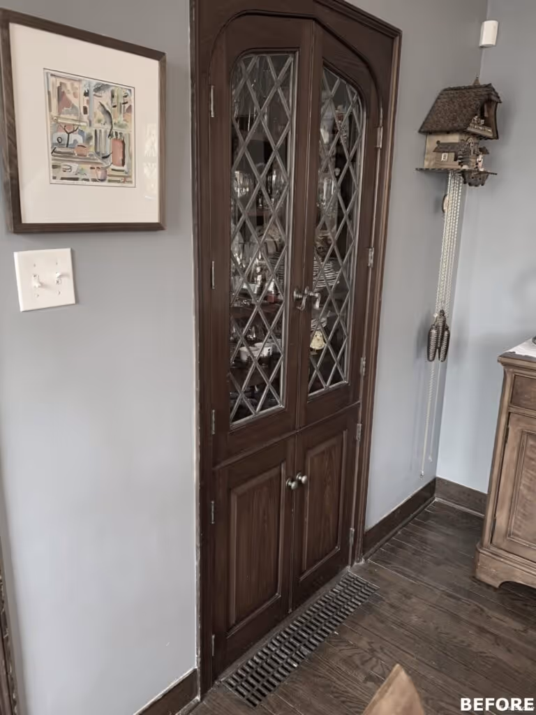 Classic wooden doors with diamond glass inserts and a framed art piece in a room in Harrisburg, PA.