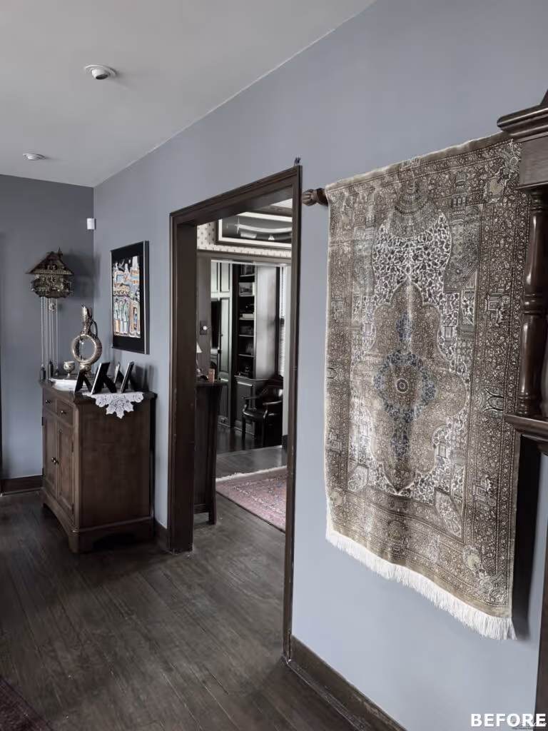 Charming transitional hallway with decorative rug, wooden furniture, and gray walls in Harrisburg, PA.