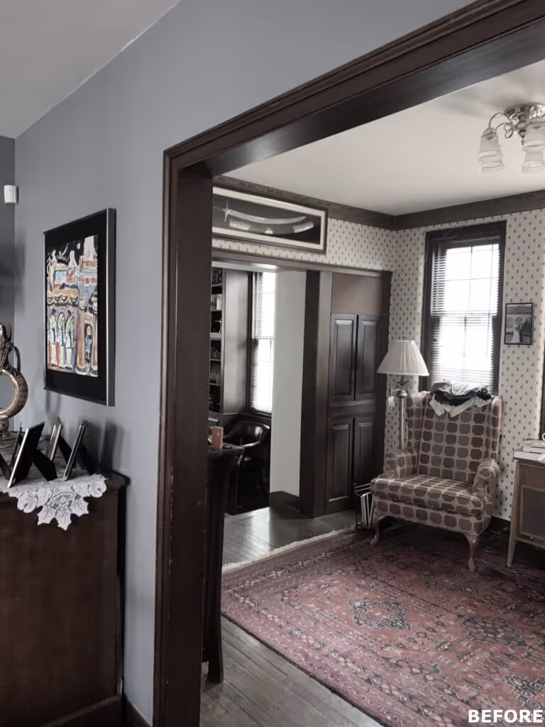 Transitional living room with patterned wallpaper, wooden accents, and cozy seating in Harrisburg, PA