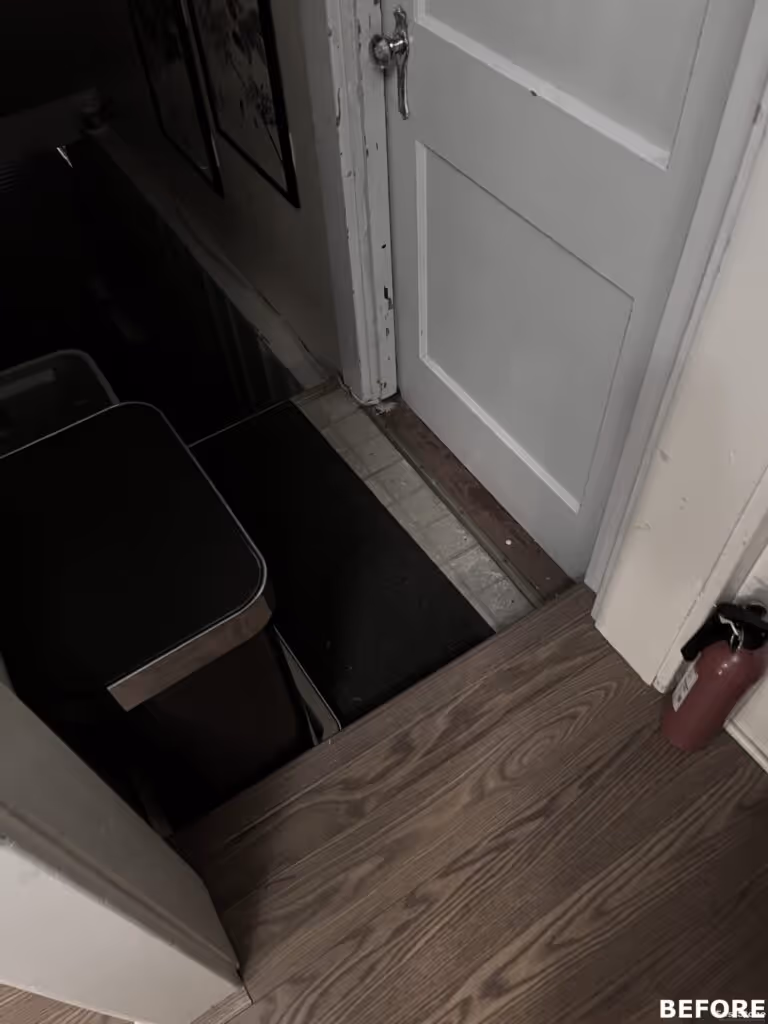 Interior view of a doorway leading downstairs with wooden flooring and a fire extinguisher in a home in camp hill, pa.