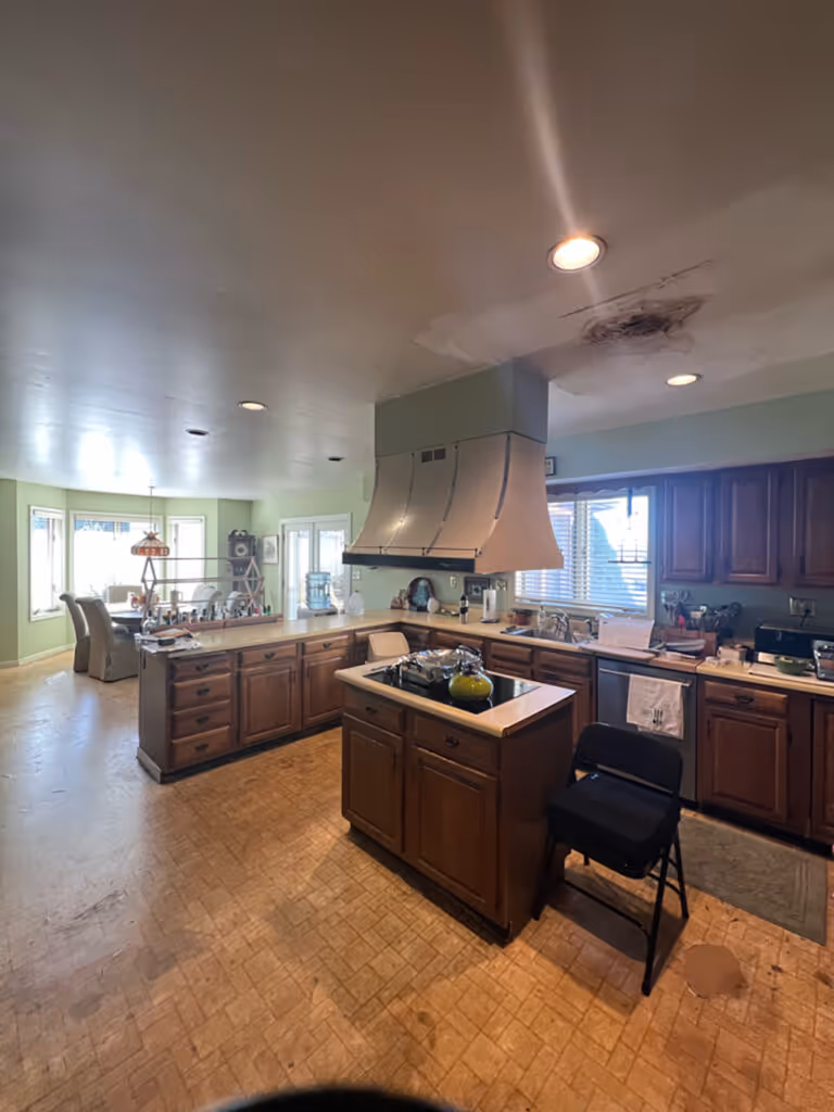 Spacious kitchen with wooden cabinets, a large range hood, and plenty of natural light in Mechanicsburg, PA.