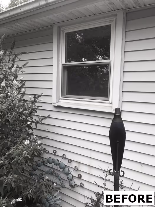 Vintage-style home exterior with a window, green plants, and decorative details in Harrisburg, PA