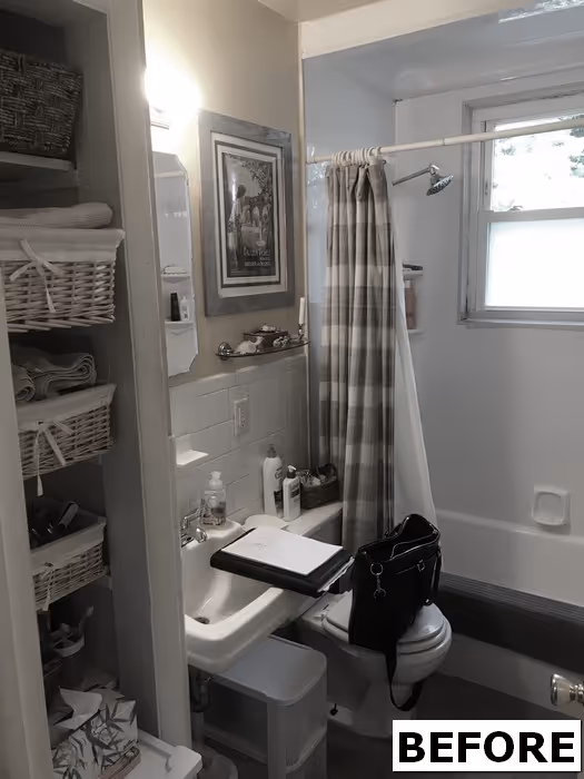 Small vintage bathroom in Harrisburg, PA, featuring a white sink, striped shower curtain, and shelving with towels.