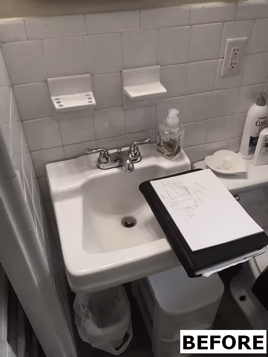 Small bathroom sink area featuring white tiled walls, basic fixtures, and design plans in Harrisburg, PA