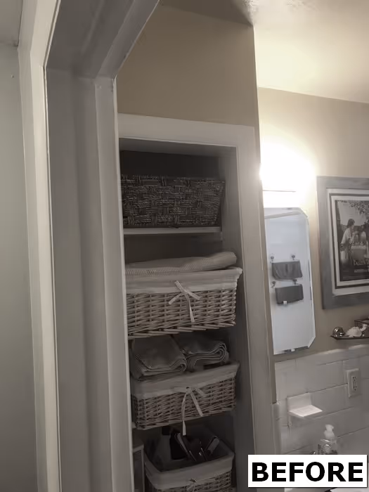 Before image of a cozy bathroom storage area in Harrisburg, PA featuring white baskets and soft towels
