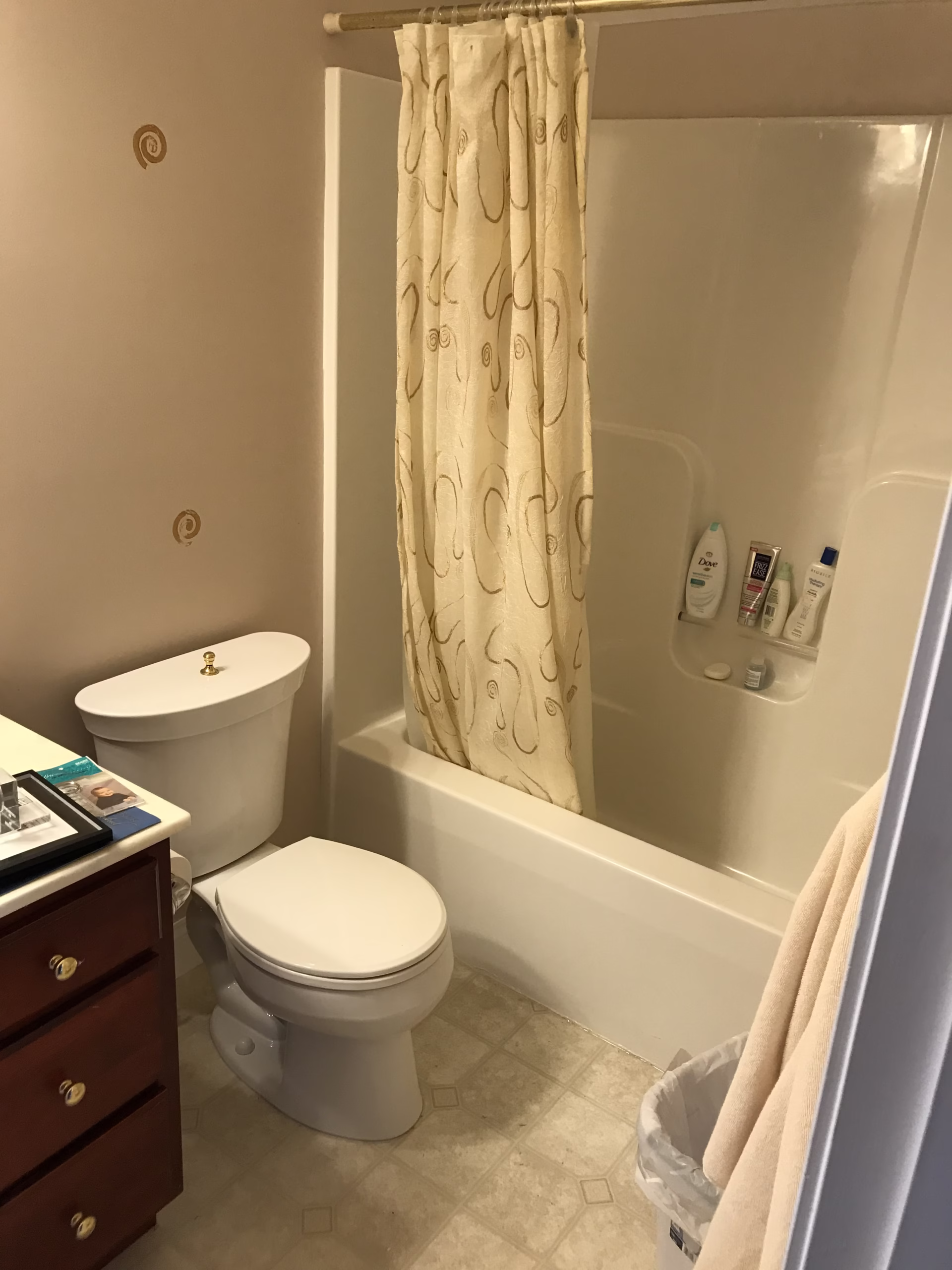 Transitional bathroom in Mechanicsburg, PA featuring a shower, toilet, and decorative shower curtain.