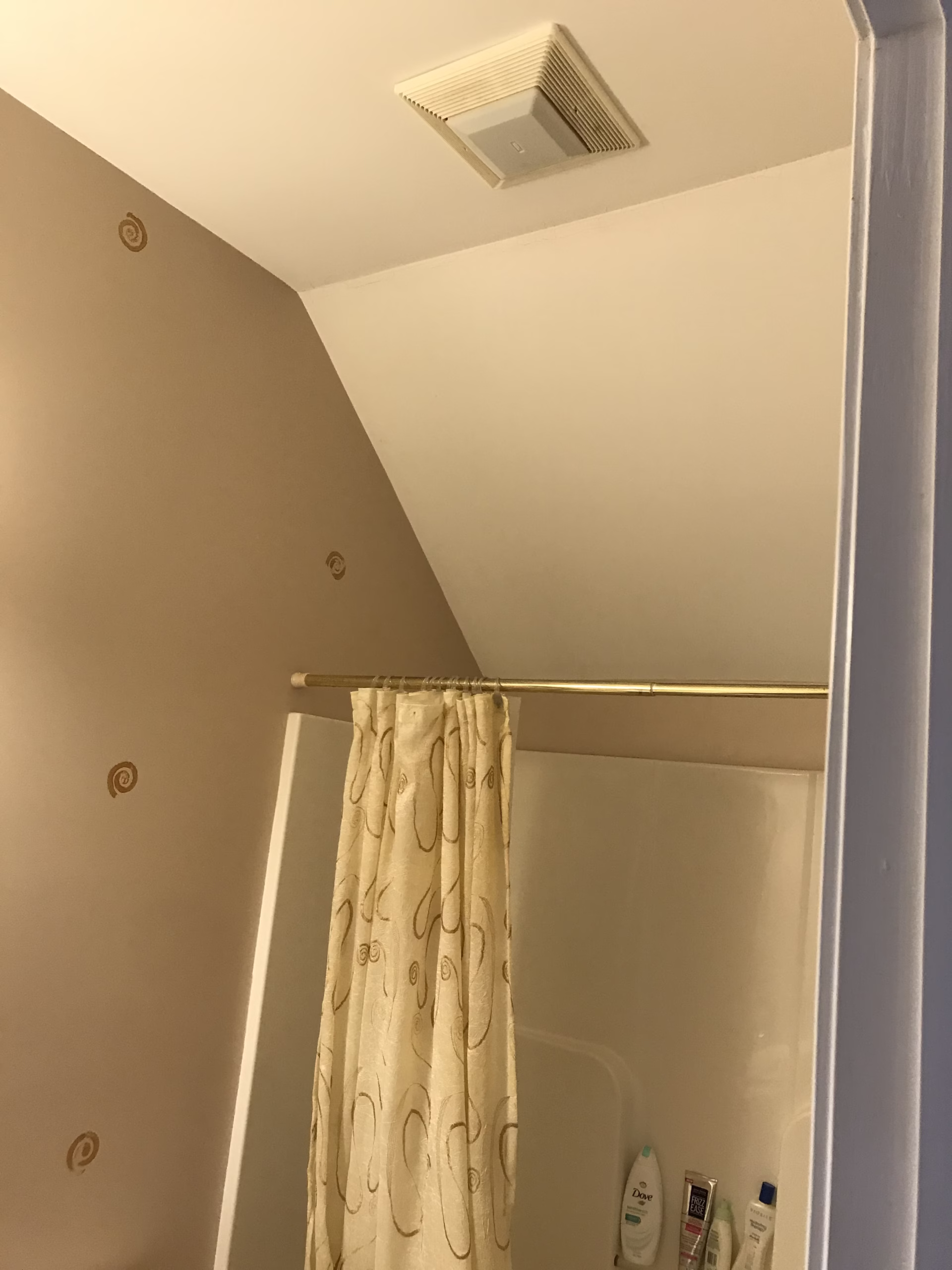 Cozy bathroom shower with beige walls, decorative accents, and a shower curtain in Mechanicsburg, PA.