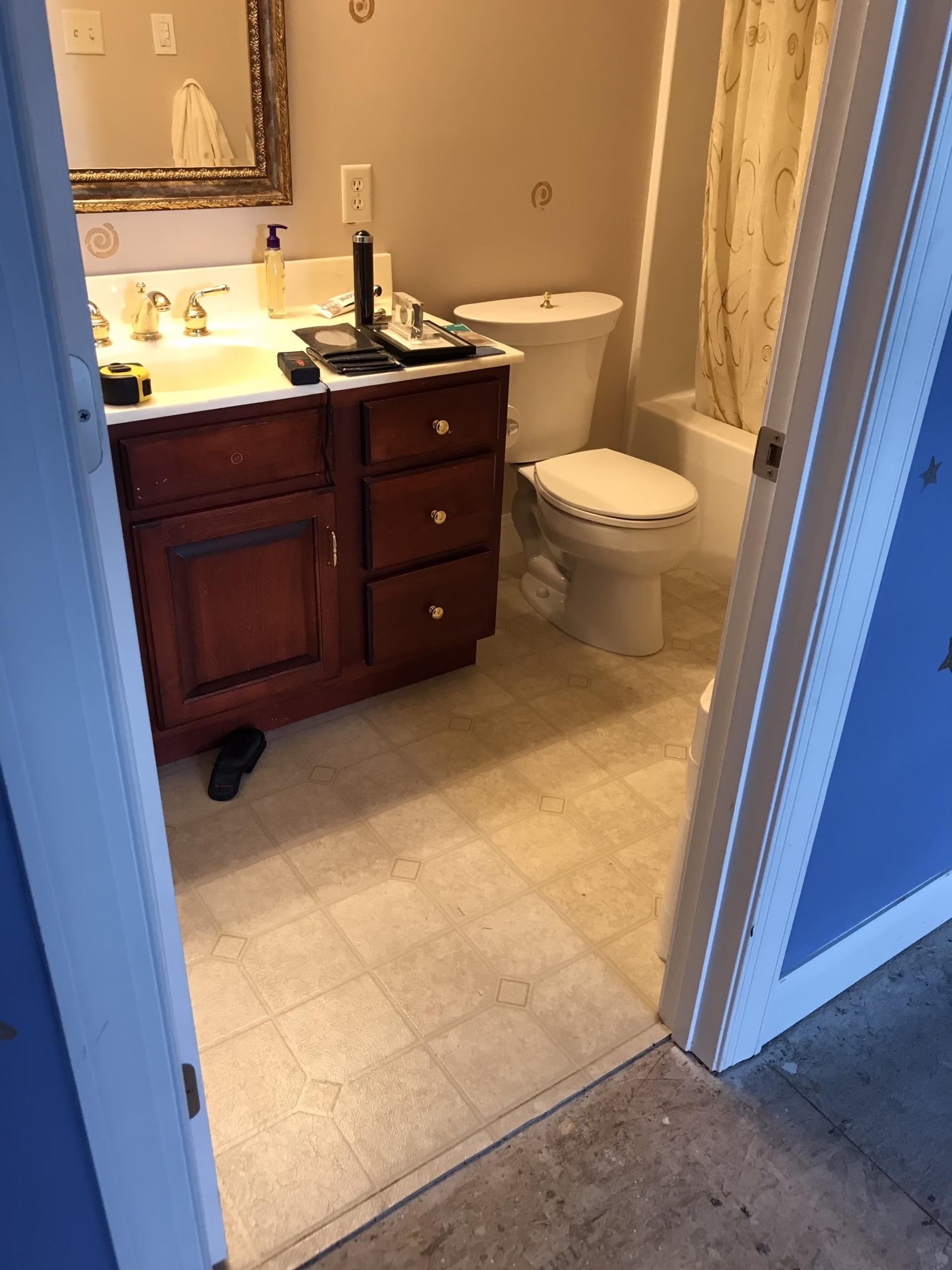 Traditional bathroom vanity featuring wooden cabinets, a sink, and a bathtub in Mechanicsburg, PA.