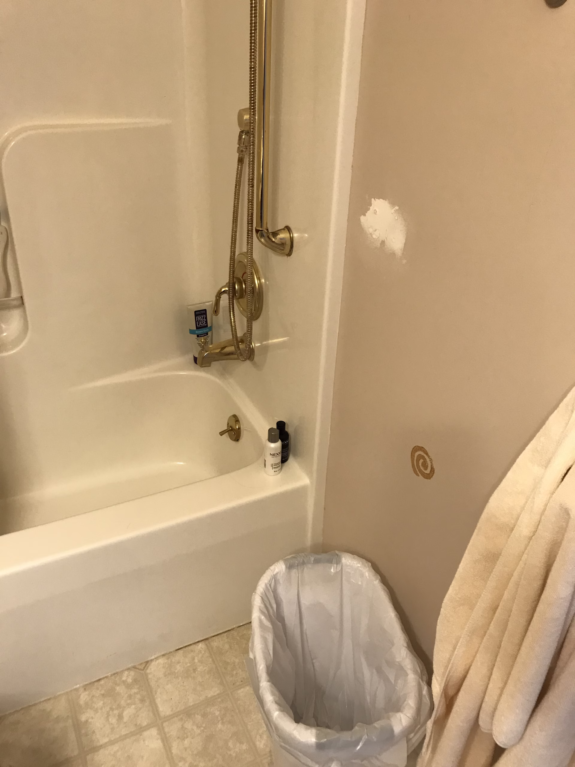 Transitional bathroom fixtures in Mechanicsburg, PA featuring a shower, bathtub, and storage elements.