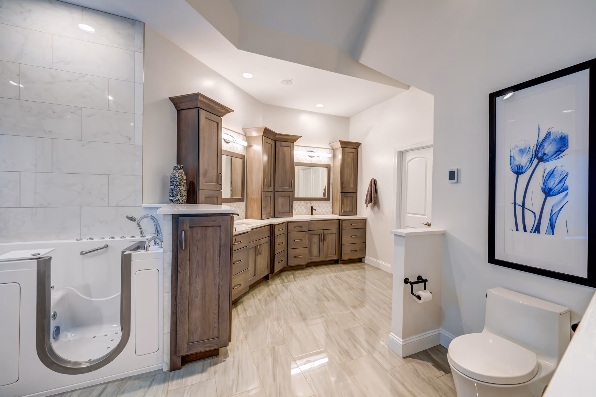 Accessible bathroom in Mechanicsburg, PA featuring a bathtub with walk-in access, elegant wooden cabinetry, and modern lighting.