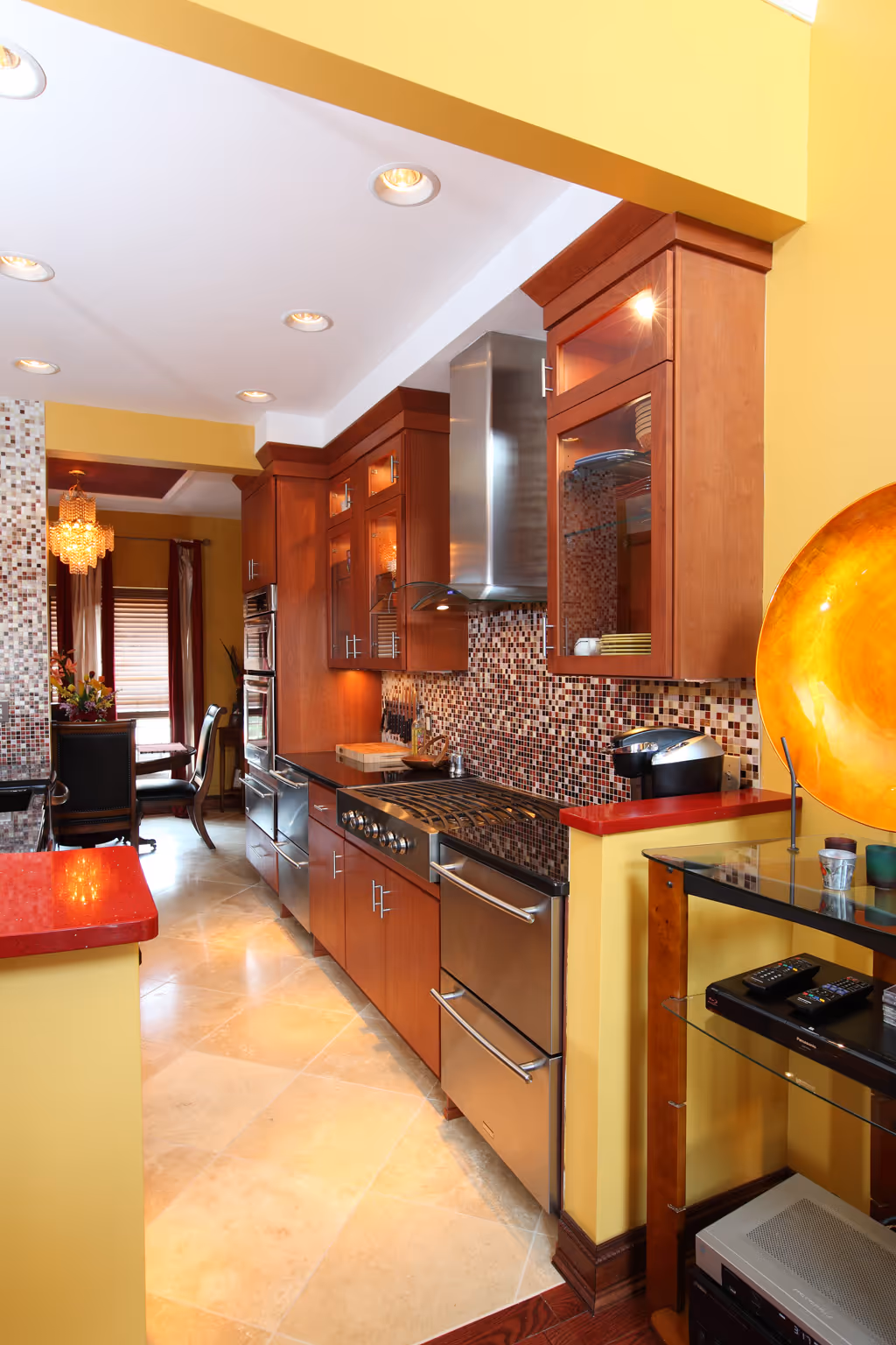 Modern kitchen with wooden cabinets and stainless steel appliances featuring a mosaic backsplash in Harrisburg, PA