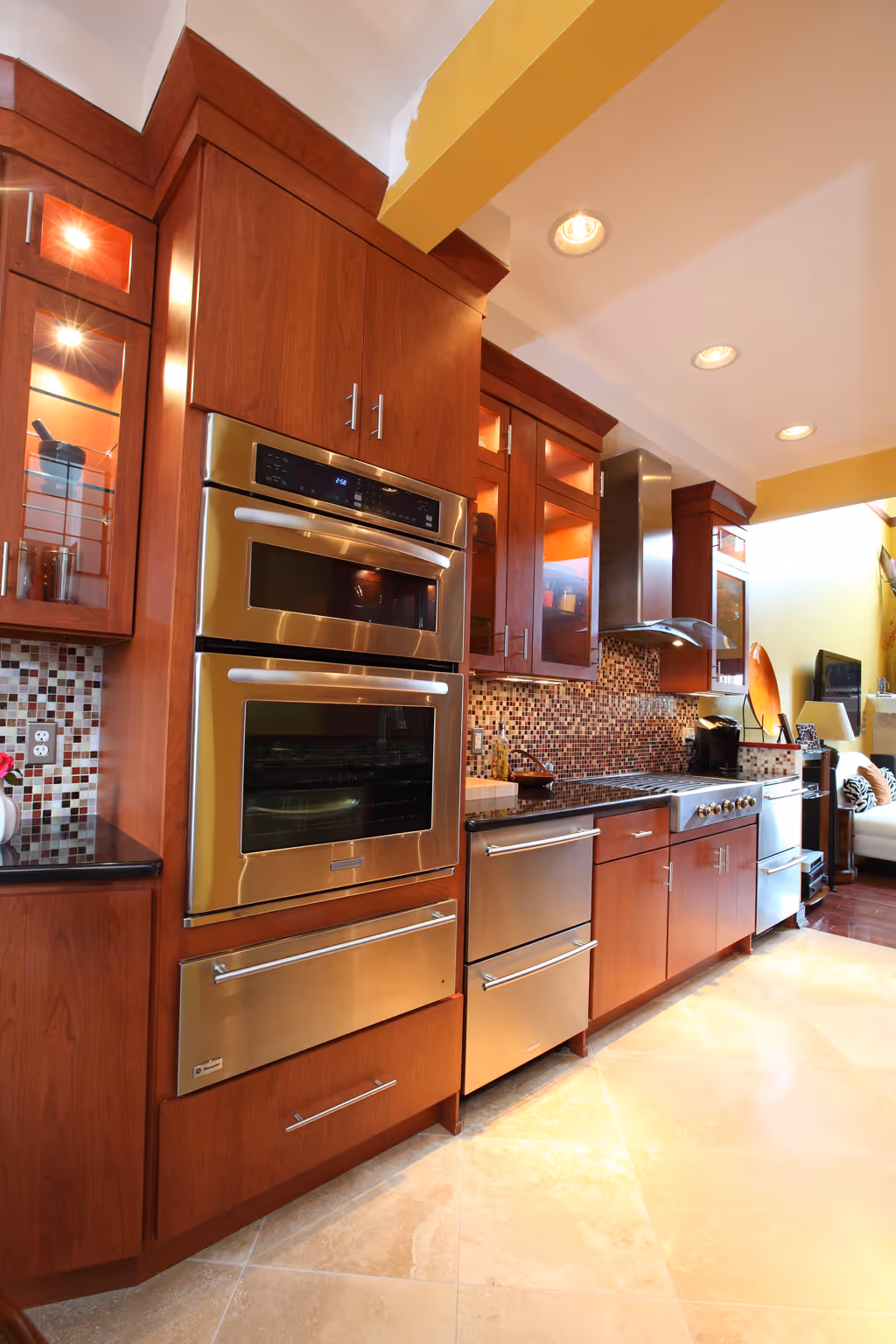 Modern kitchen in Harrisburg, PA featuring sleek cabinets, stainless steel appliances, and a vibrant mosaic backsplash.
