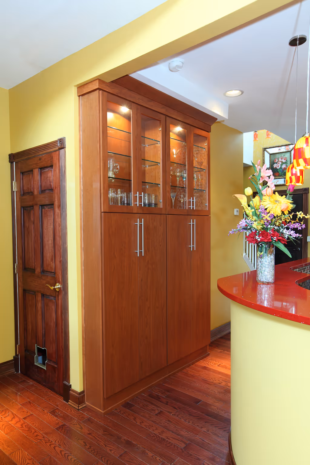 Modern kitchen corner with dark wood cabinets and red countertop in Harrisburg, PA