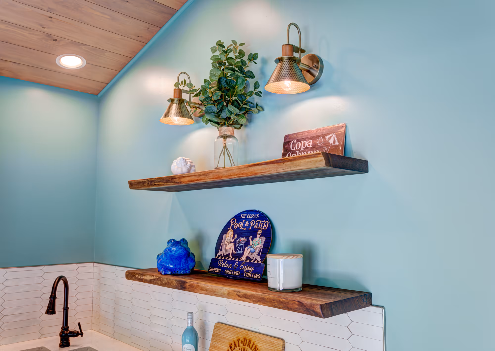 Stylish kitchen with teal walls, open wood shelving, and decorative plants in gettysburg, pa