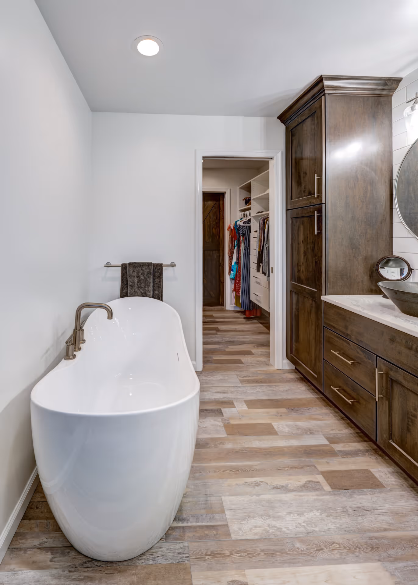 Transitional bathroom in Elizabethtown, PA featuring a freestanding tub and dark wood cabinetry.