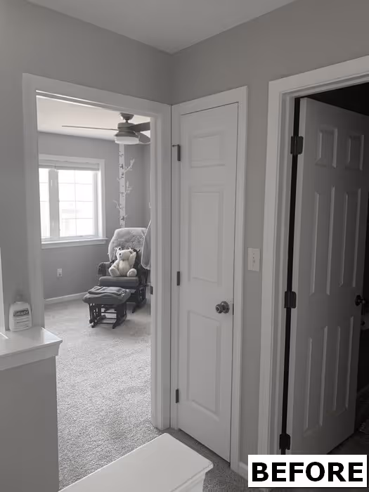 Cozy transitional bedroom in elizabethtown, pa featuring gray walls, plush carpet, and a stylish rocking chair.