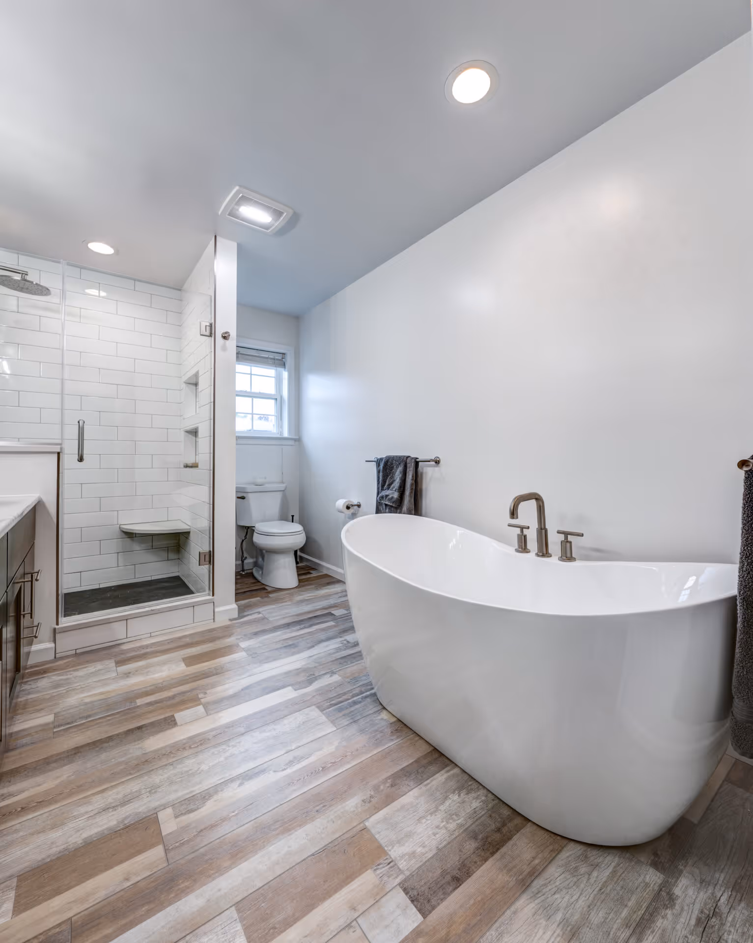 Luxurious modern bathroom in Elizabethtown, PA featuring a freestanding tub and glass shower.