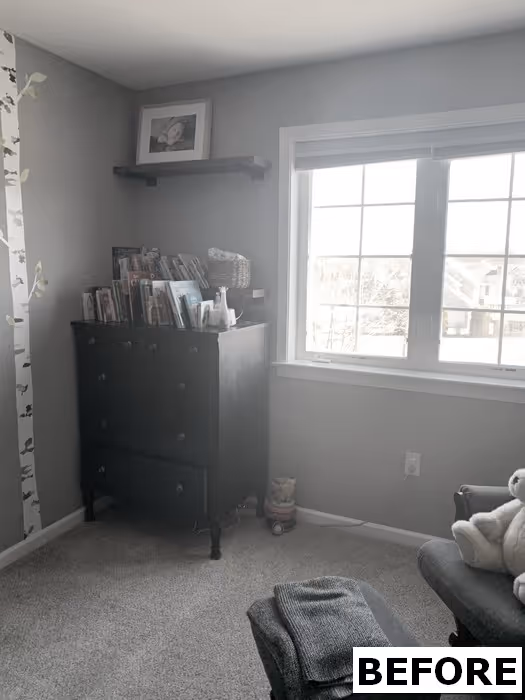 Cozy children's bedroom in Elizabethtown, PA with a dark dresser and bookshelves, featuring gray walls and a sunny window.