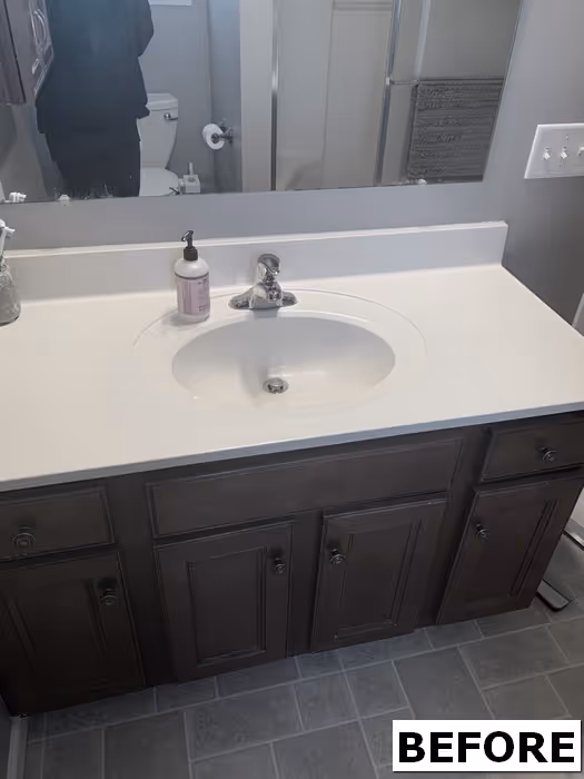 Modern bathroom with dark wood cabinetry and white countertop in Elizabethtown, PA