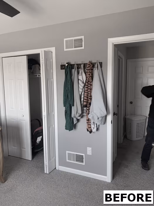 Modern bedroom with gray walls, storage doors, and hanging blankets in Elizabethtown, PA