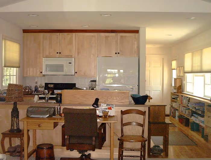Contemporary kitchen and dining area in Boiling Springs, PA featuring light wood cabinets and a cozy workspace.